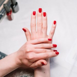 person with red nail polish